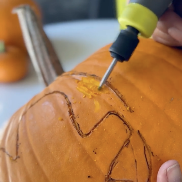 carving ghost pumpkin