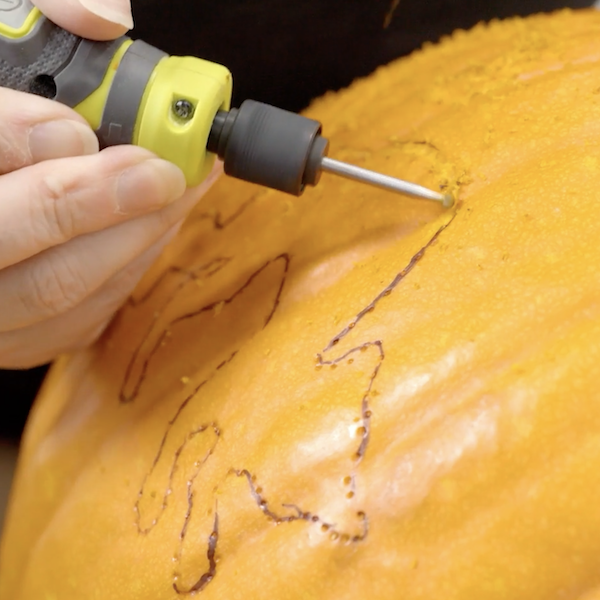 Engraving the design into the pumpkin