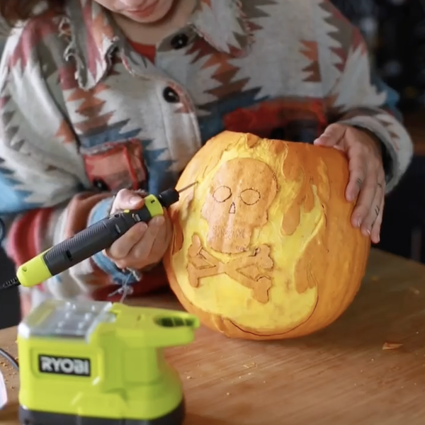 carving the design onto the pumpkin
