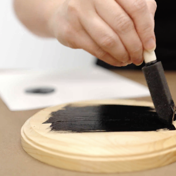 Applying paint to wood plaques