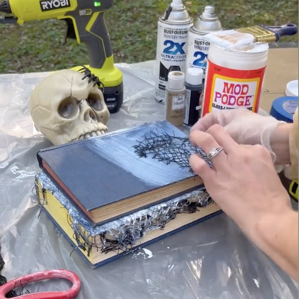 Attaching netting fabric to books.