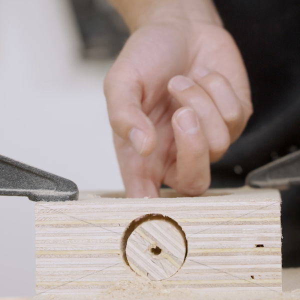 Drill a pilot hole through a block
