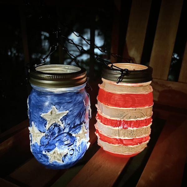 Glass jars with lit candles