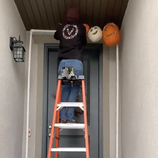 Attaching pumpkins to the arch