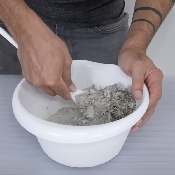 Mix concrete together in a large bowl. Create one bowl containing the plain concrete, then make a second bowl with colored concrete. 