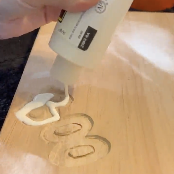 Filling the carved letters with resin