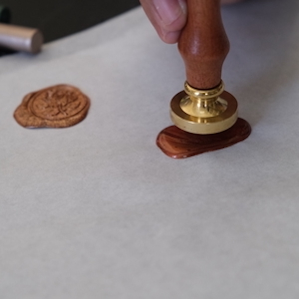 Pressing stamp into wax